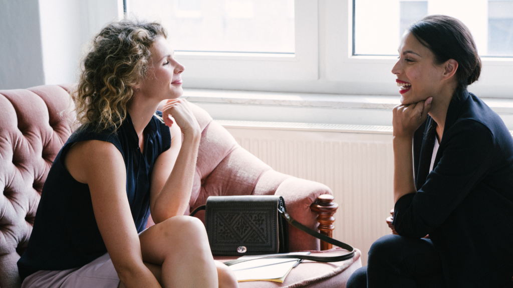 This is a photo of two women sitting face to face in a coaching conversation.