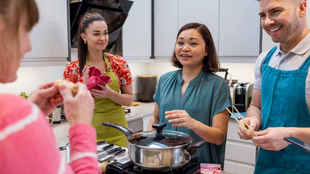 People using their emotional intelligence and interpersonal skills to cook a meal. 