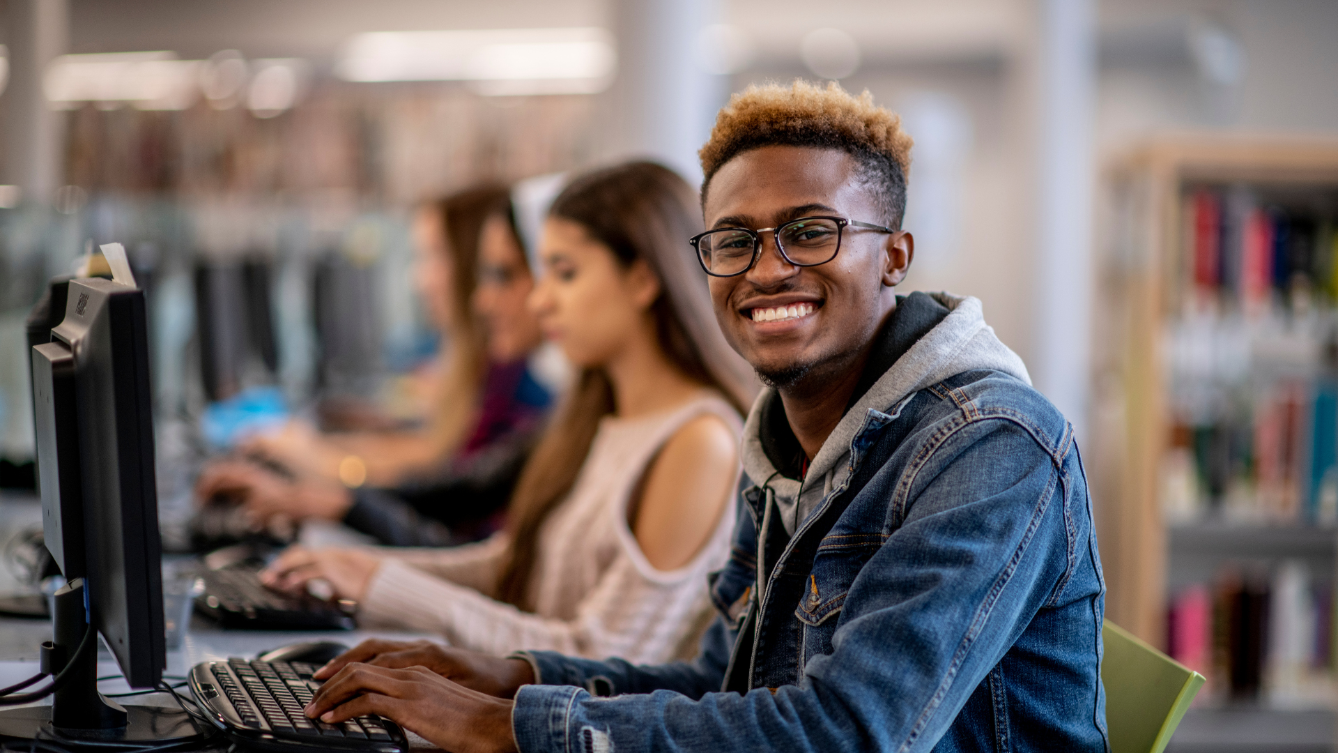 This is a picture of a student at a computer desk.